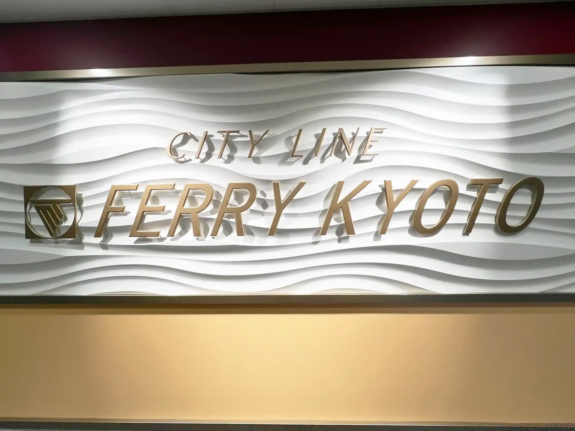 a logo object on the wall of the Meimon Taiyo Ferry Kyoto entrance