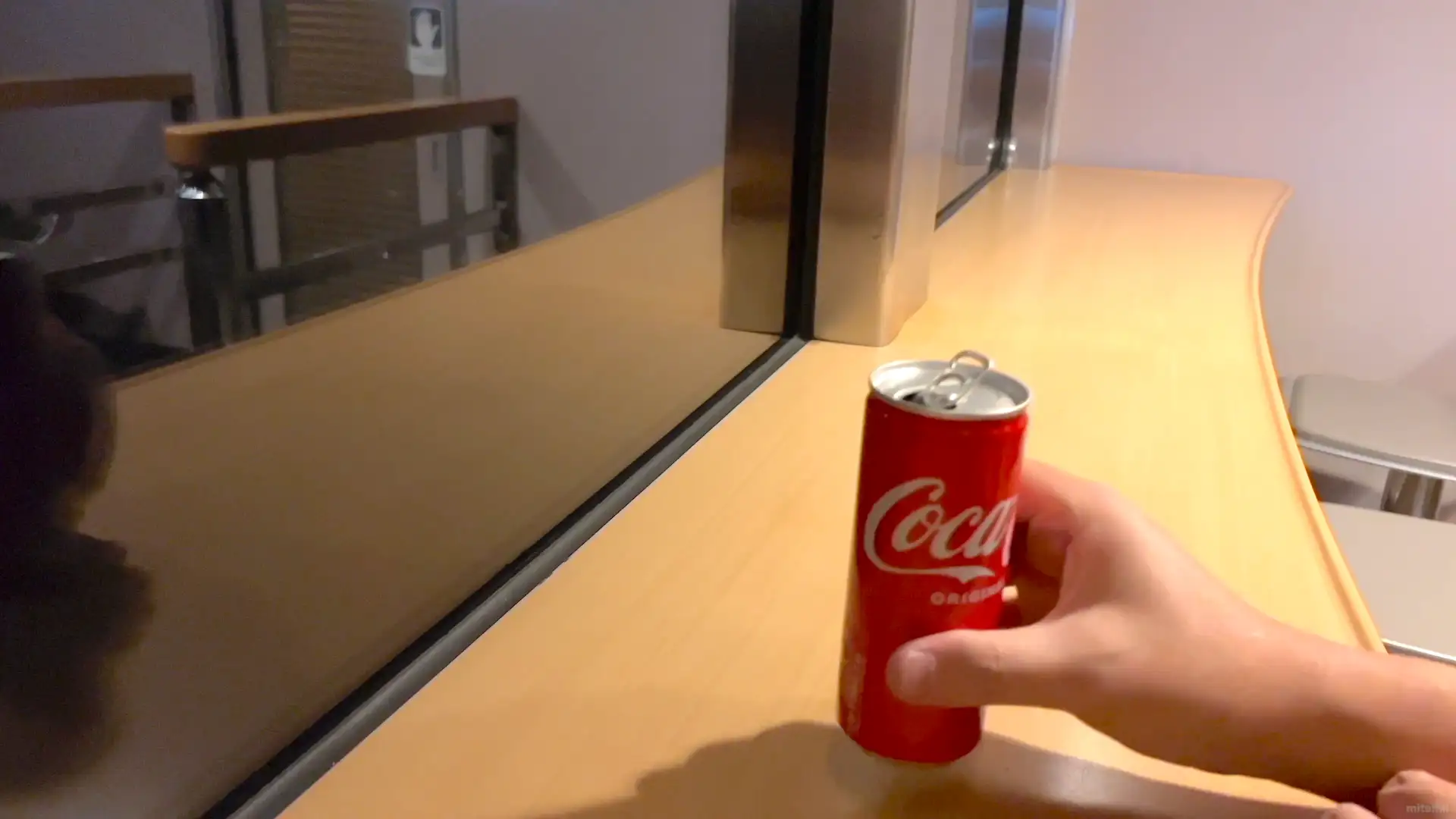 寝台特急サンライズ出雲号のミニラウンジで缶コーラを飲んでいる様子