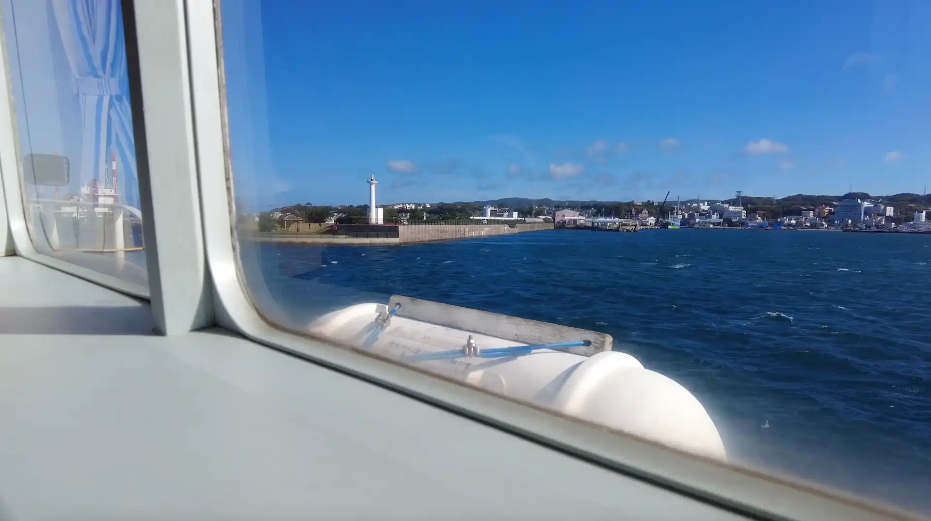 View from the window seat of Tanegashima Yakushima High-Speed Ferry Rocket 2 showing Nishinoomote Port on Tanegashima