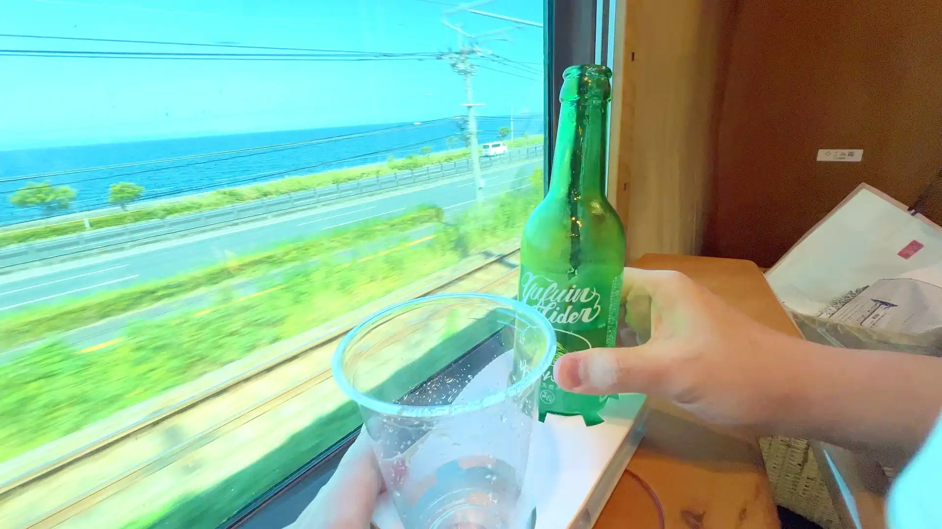 ゆふいんの森Ⅰ世のフリースペースでゆふいんサイダーを飲んでいる様子